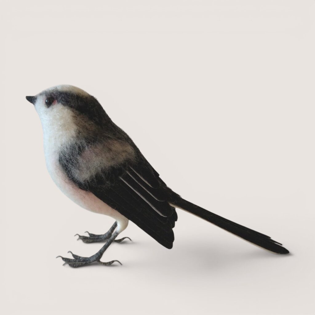 Needle felted long-tailed tit sculpture, side view