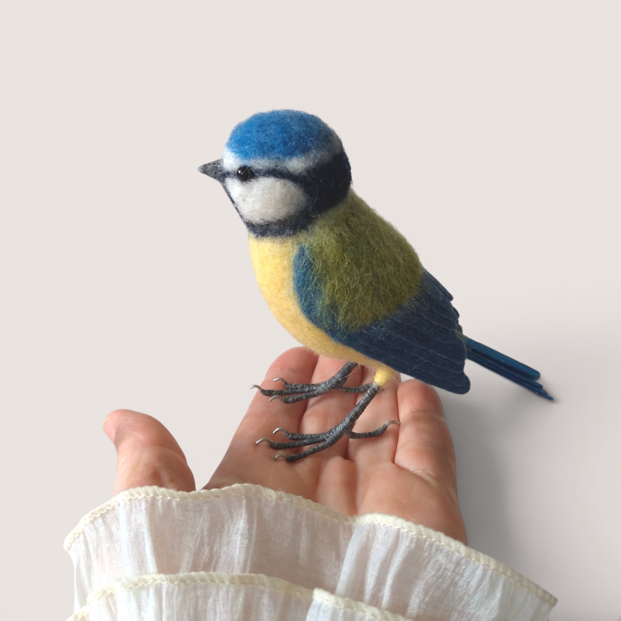 Blue Tit 4 Hand holding a handmade needle felted Blue Tit to show scale.