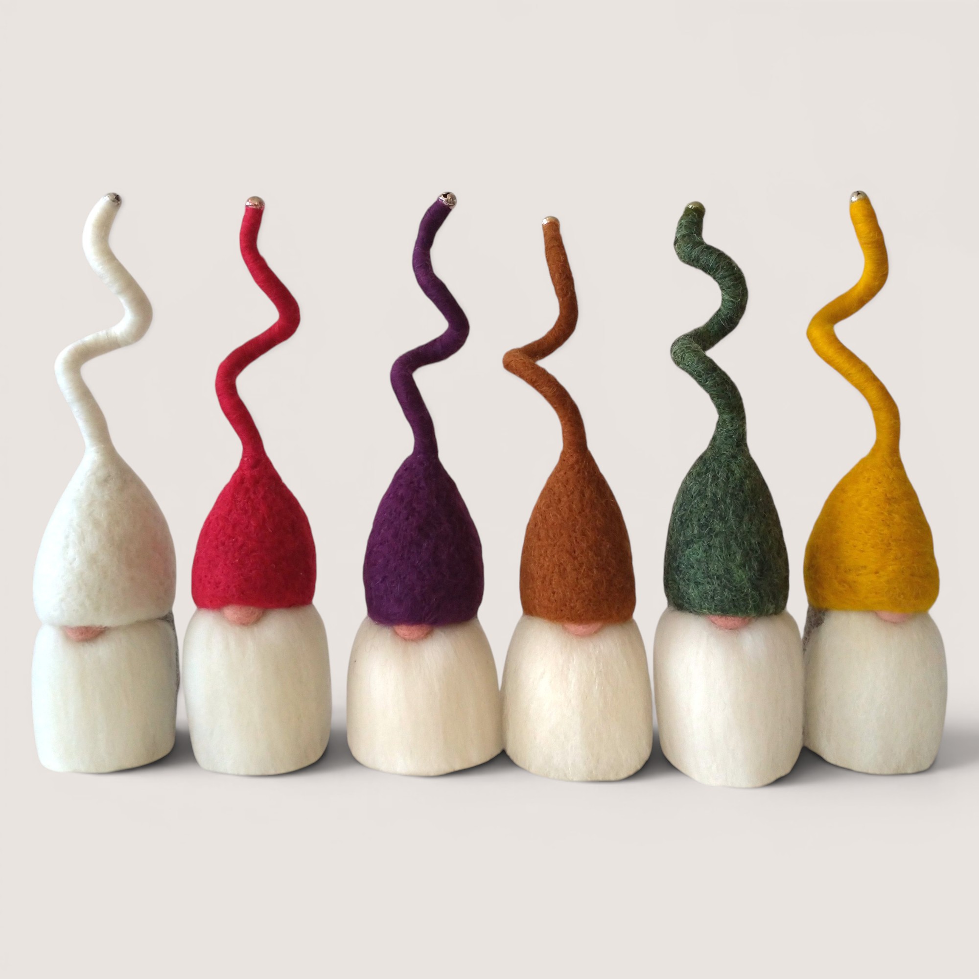 Tomten – Set of Six (Fireside Winter) 1 Needle felted Tomten set of six by Grey Wren Studio in the Raspberry Thicket colour palette shown from the front.