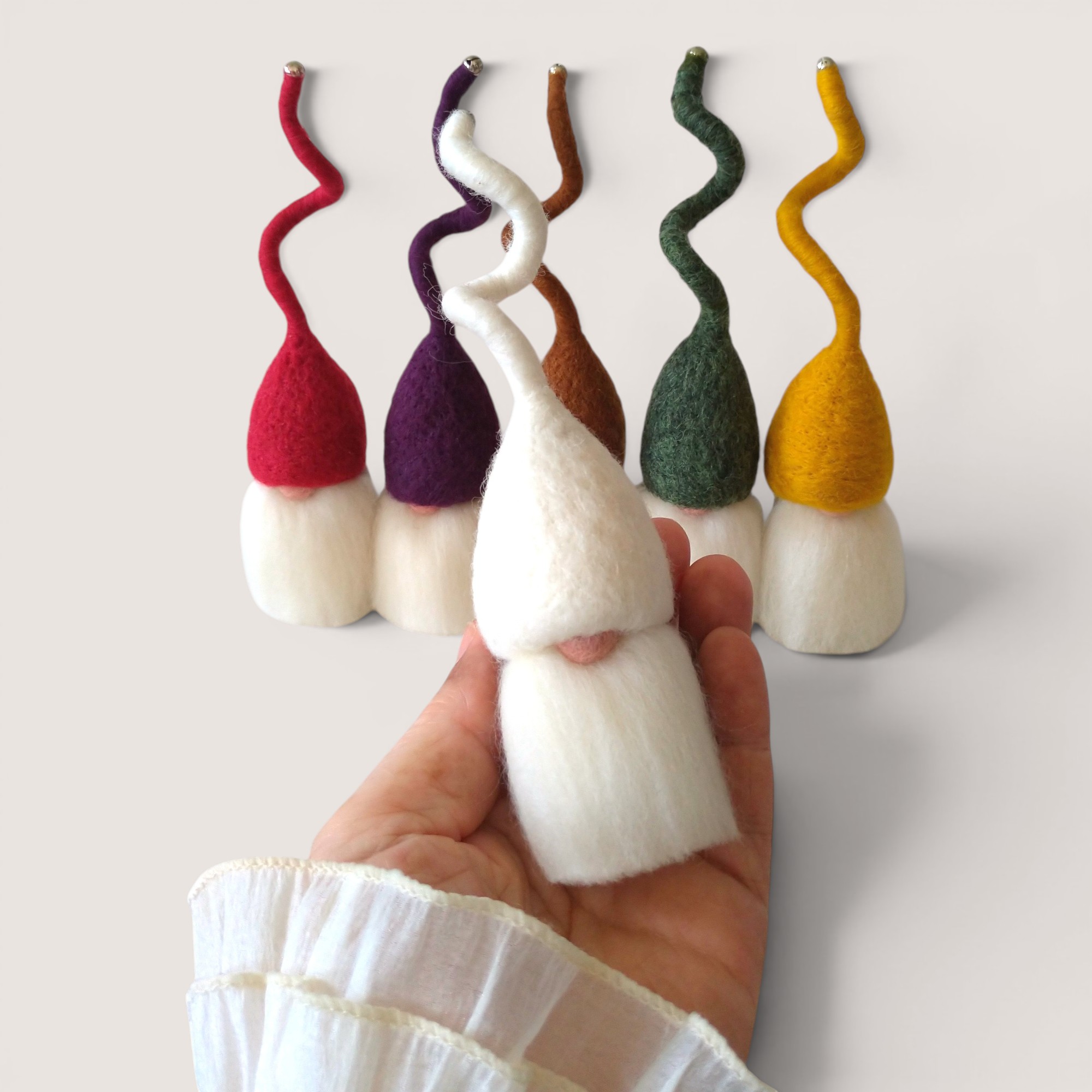 Tomten – Set of Six (Fireside Winter) 3 Needle felted Tomten from the Fireside Winter set by Grey Wren Studio held in hand to show scale.