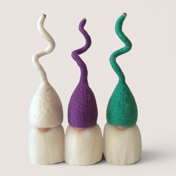 Needle felted Tomten set of three by Grey Wren Studio in Hedgerow hat colours shown from the front Needle felted Tomten by Grey Wren Studio held in hand to show scale Detail image of Tomten – Build Your Trio by Grey Wren Studio, showing the handmade needle felted wool texture, curled hats, beards and small character details.